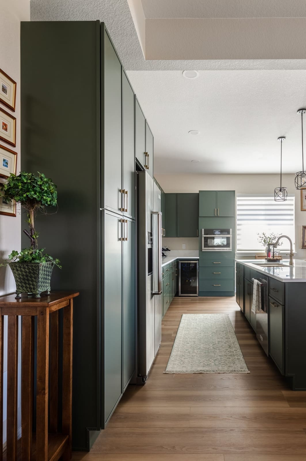 Full-height sage pantry wall leading into the kitchen